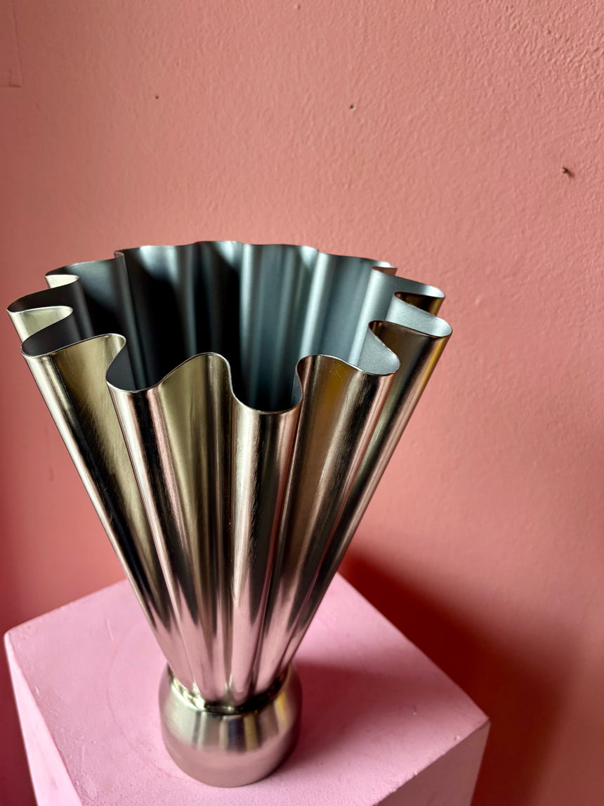 Tall wave-shaped metal vase