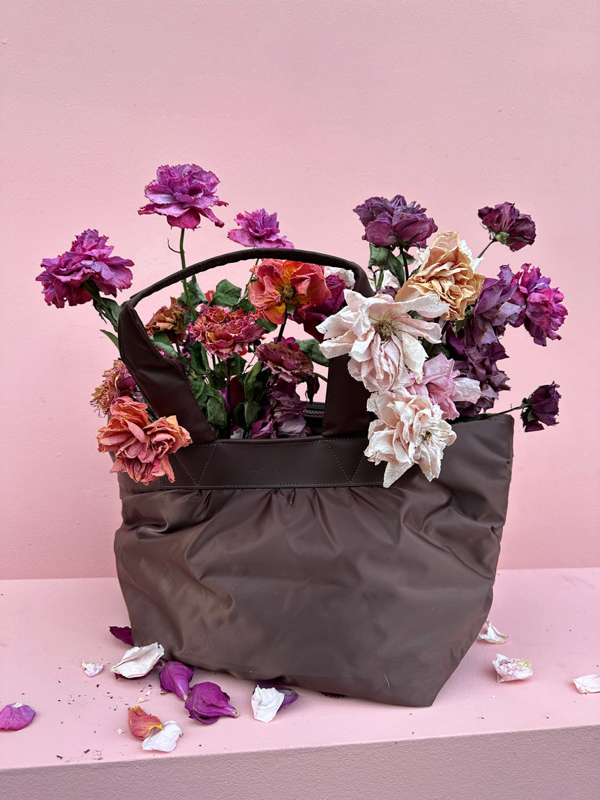 Vee Collective Porter bag with bouquet of dried flowers