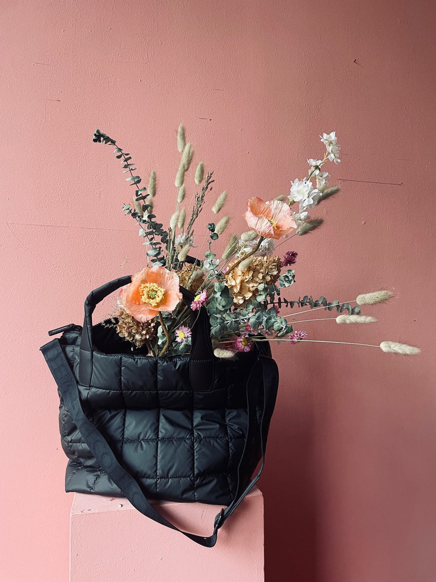 Vee Collective Porter bag with bouquet of dried flowers
